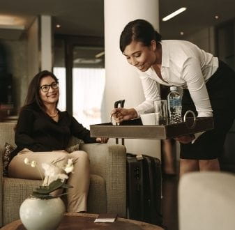 Lady serving drinks to customer