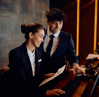Hotel managers working at front desk