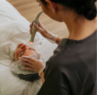 Dermal Therapist working on client