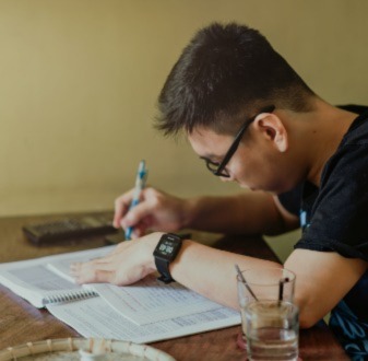 12 tips for year 12 students | Student writing in a notebook | Small