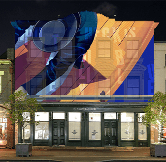 William Blue Dining lit up at night with Billy Blue projection Torrens University