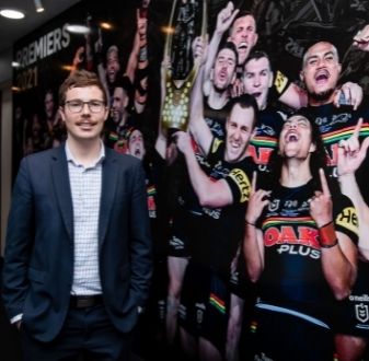 Jeremy standing in front of Penrith Panthers wall