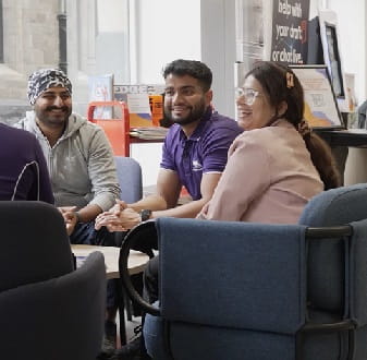 Four friends laughing together