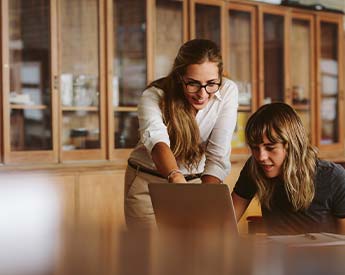 Torrens University Australia | Women Discussing on Laptop