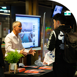 Torrens University | Open Day | Staff helping student at booth