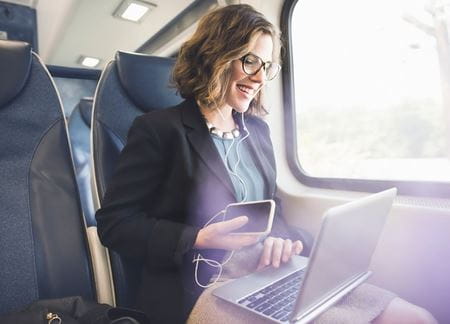 Lady on laptop while commuting