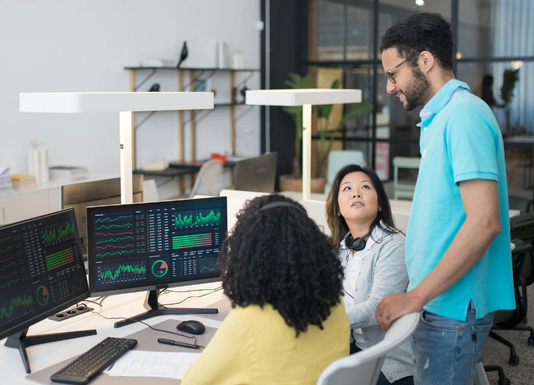 man with women sitting in front of screen analytics