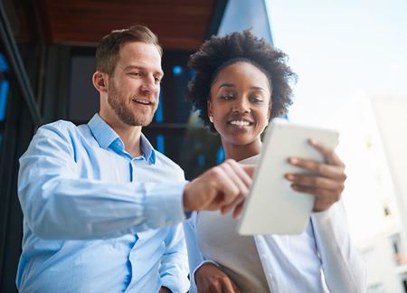 master of business administration and master of public health man showing women something on a tablet hero image | Torrens University
