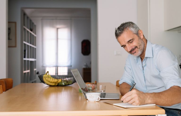 Man studying on laptop sitting at a desk