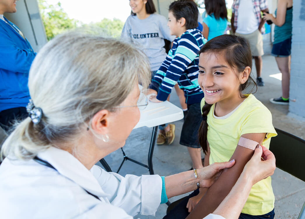 health courses women putting band aid on child hero | Torrens University