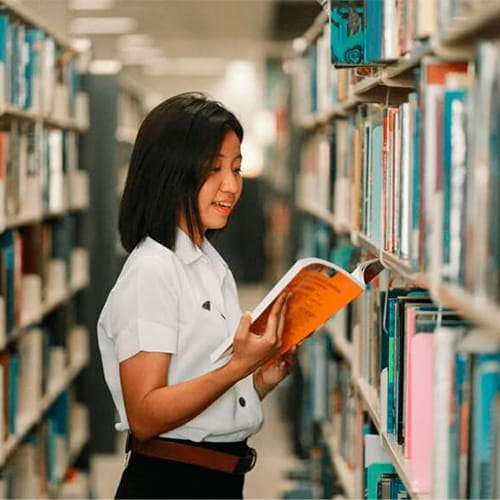 International student reading in university library